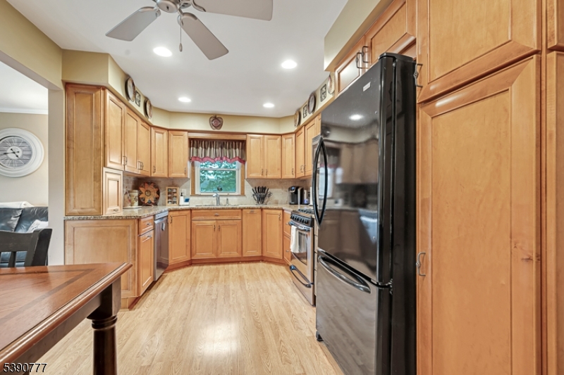 279 Madison Hill Road Clark, NJ 07066 - Photo 7 of 35 a kitchen with a refrigerator a sink and cabinets
