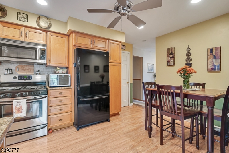279 Madison Hill Road Clark, NJ 07066 - Photo 9 of 35 a kitchen with stainless steel appliances kitchen island granite countertop a refrigerator and a stove top oven