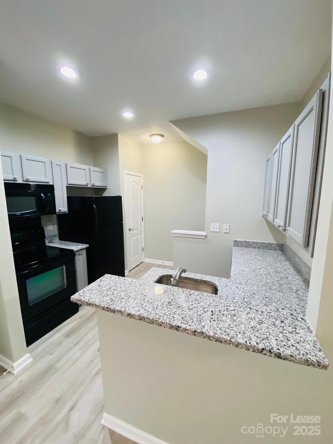 1646 Termini Drive Charlotte, NC 28262 - Photo 3 of 8 a kitchen with sink refrigerator and stove