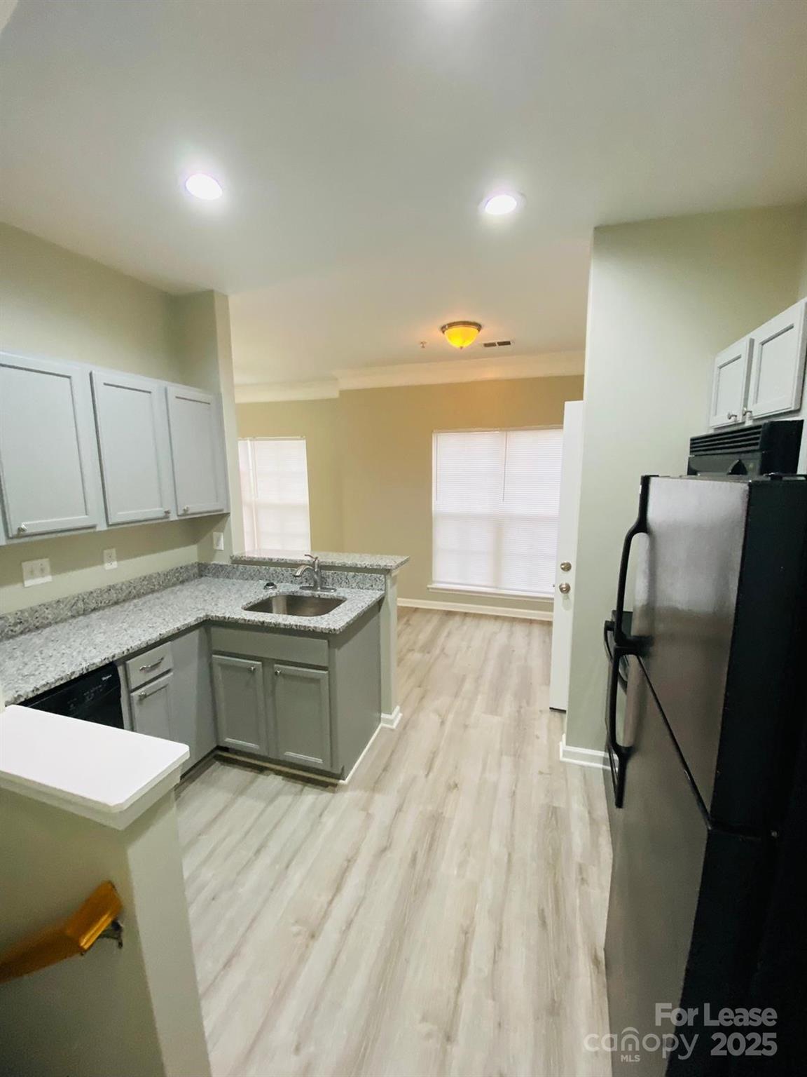 1646 Termini Drive Charlotte, NC 28262 - Photo 4 of 8 a kitchen with stainless steel appliances granite countertop a stove a sink dishwasher and cabinets with wooden floor
