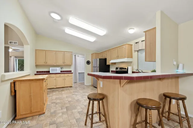 a kitchen with stainless steel appliances granite countertop a sink and cabinets