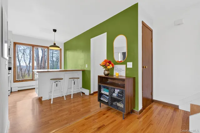 a view of living room with furniture and wooden floor