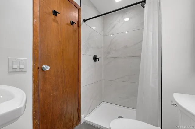 a bathroom with a shower a toilet and a shower