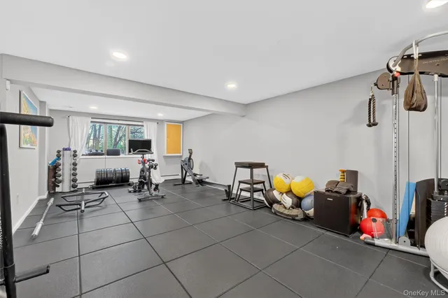 a living room with furniture and gym equipment