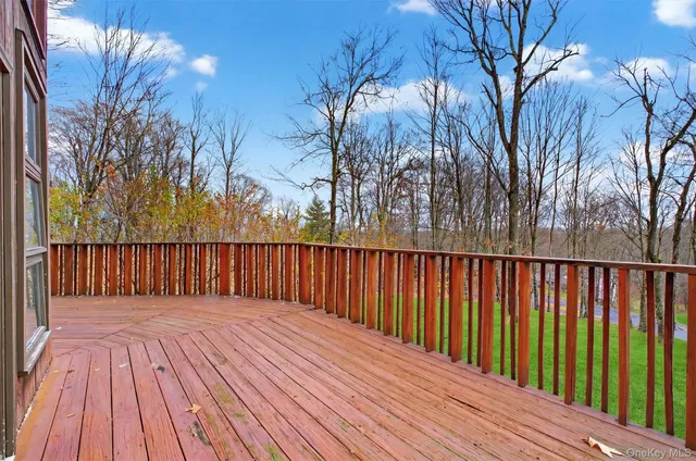 a balcony with wooden floor and trees