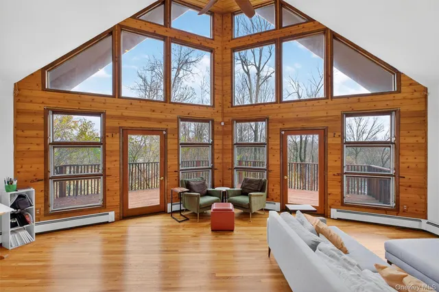 a living room with furniture and floor to ceiling windows