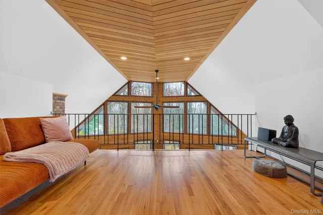 a bedroom with furniture and wooden floor
