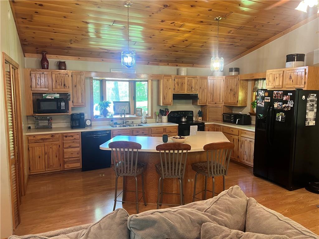 121 Pitts Road Jamestown, PA 16134 - Photo 14 of 28 a kitchen with stainless steel appliances granite countertop a sink wooden cabinets table and chairs