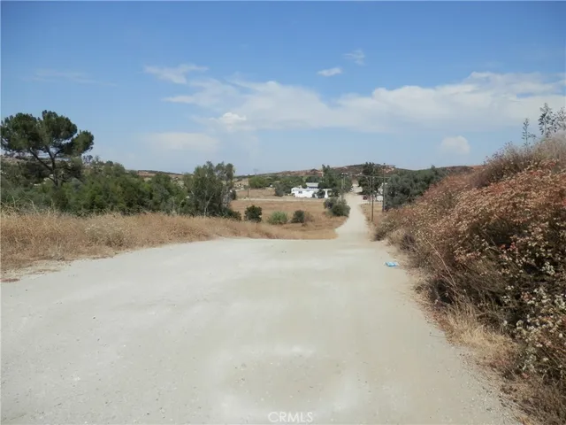 an aerial view of a house with a yard and mountain view in back