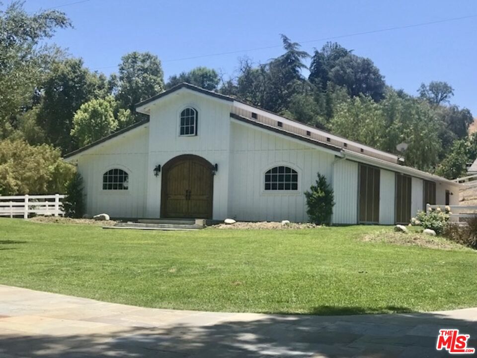 24024 Long Valley Road Hidden Hills, CA 91302 - Photo 2 of 6 a front view of a house with a yard