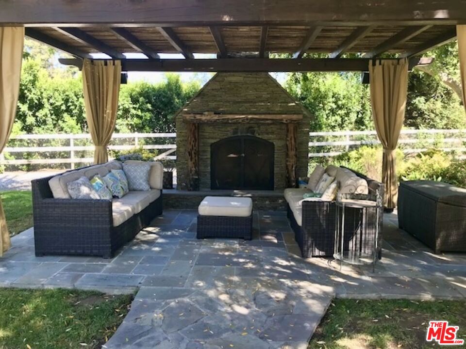 24024 Long Valley Road Hidden Hills, CA 91302 - Photo 6 of 6 a living room with furniture and a fireplace