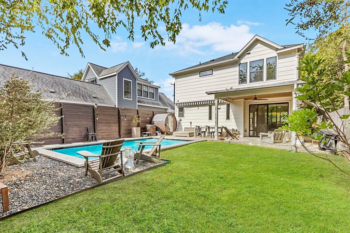a view of a house with a yard patio and a small yard