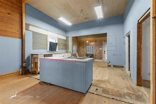 a view of living room with furniture and wooden floor