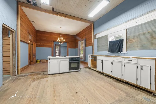 a view of a kitchen with a sink and cabinets