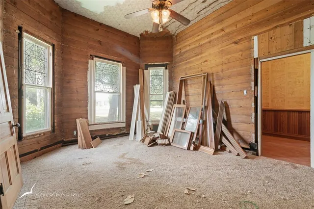 a view of a livingroom with furniture and a gym equipment