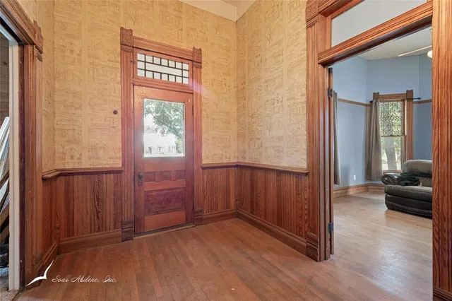 a view of an entryway with wooden floor