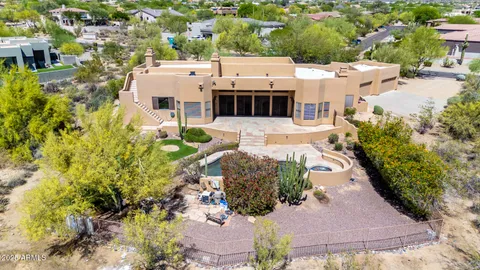 a aerial view of a house with a yard and plants