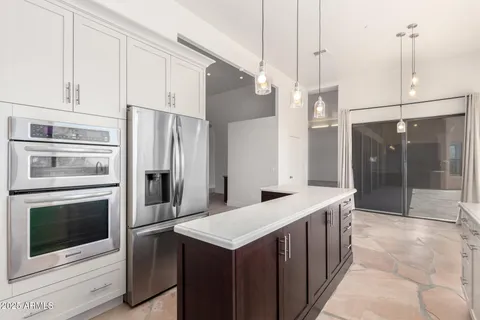 a kitchen with a sink and stainless steel appliances