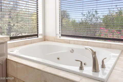 a bathroom with bathtub and window