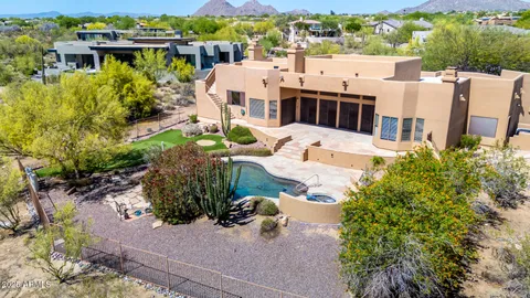 an aerial view of a house with a yard basket ball court and outdoor seating