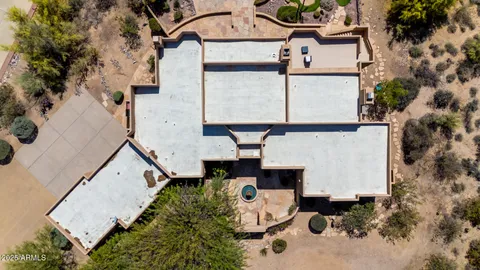an aerial view of residential houses with city view