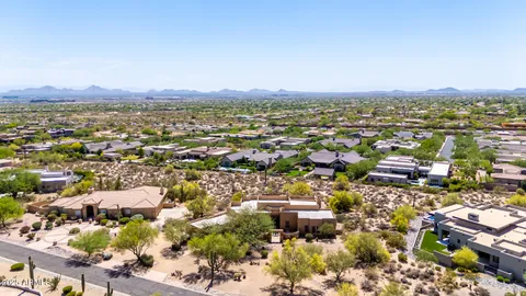 an aerial view of residential building with green space