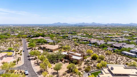 an aerial view of residential houses with city view