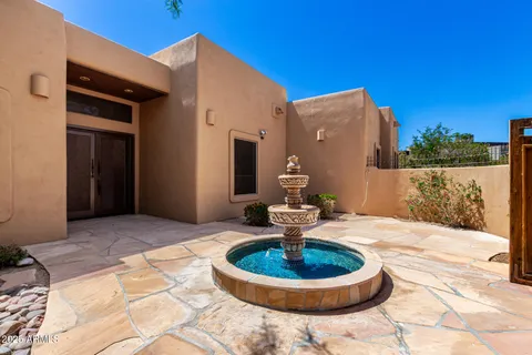 a swimming pool with some potted plants