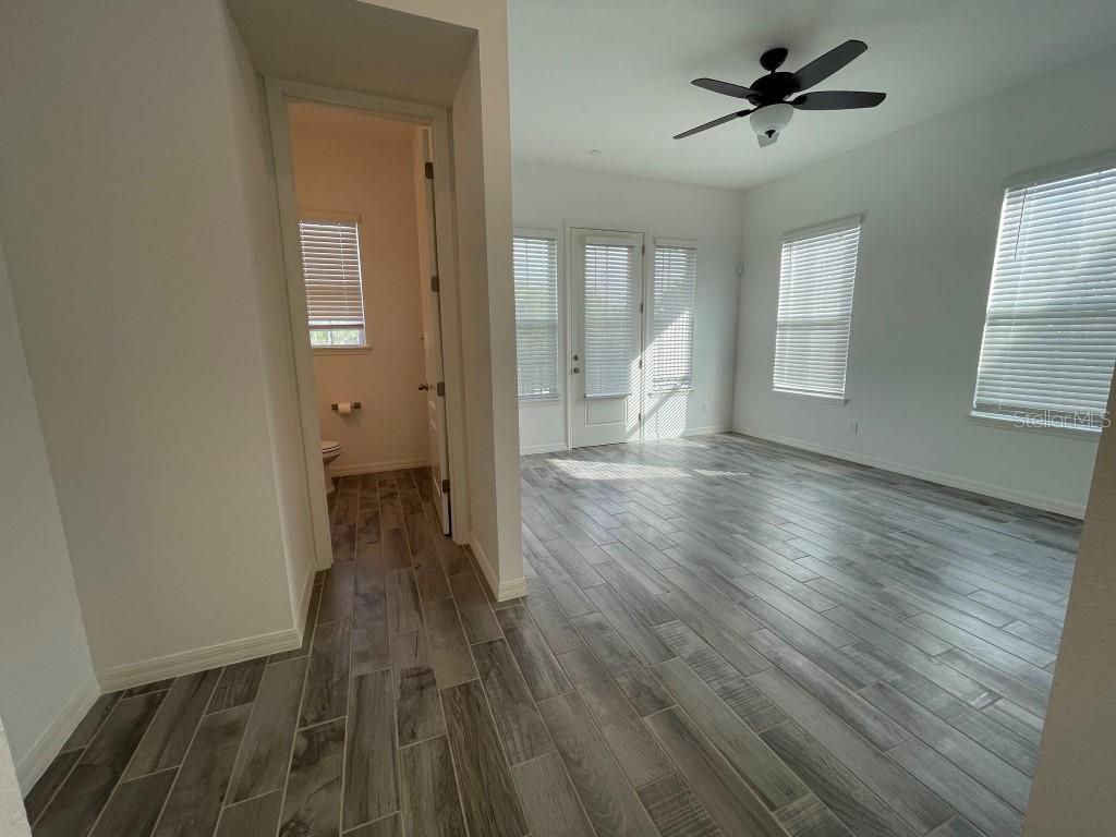 191 Sun Palm Lane Altamonte Springs, FL 32701 - Photo 8 of 16 a view of empty room with wooden floor and fan