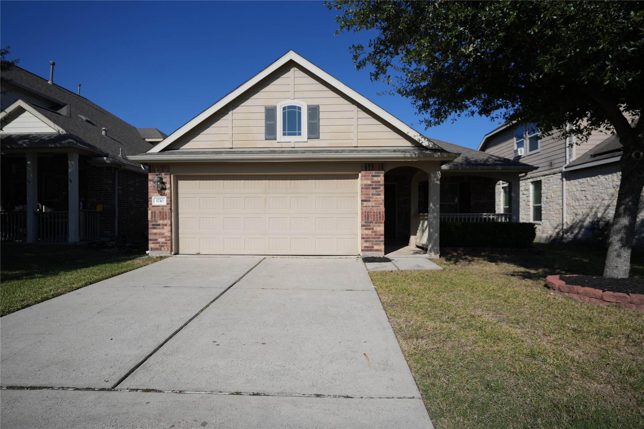 1710 Thornhampton Court Houston, TX 77014 - Photo 1 of 17 a front view of a house with a yard and garage