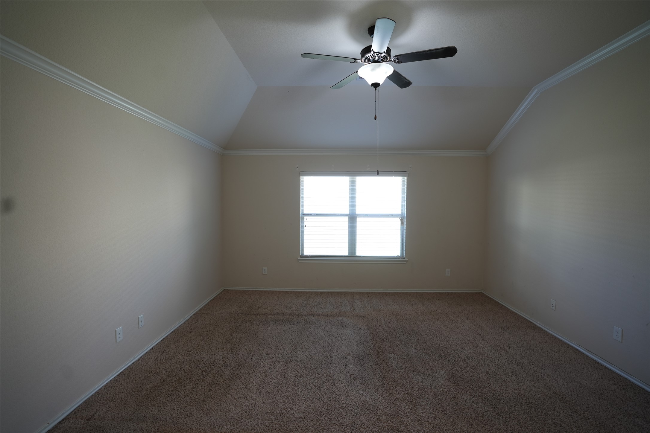 1710 Thornhampton Court Houston, TX 77014 - Photo 11 of 17 an empty room with a chandelier fan and windows