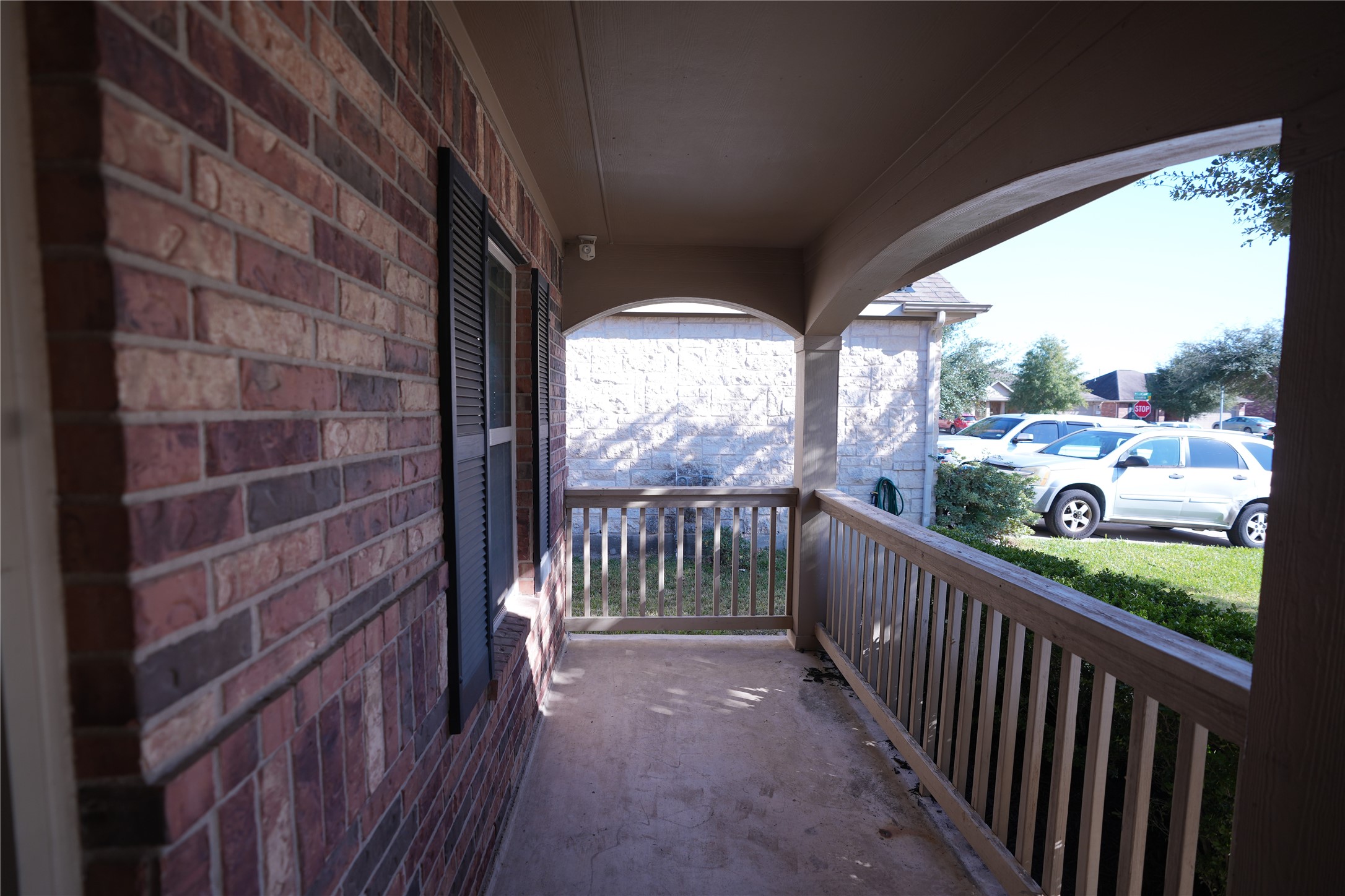1710 Thornhampton Court Houston, TX 77014 - Photo 3 of 17 a view of a porch with wooden floor and iron stairs