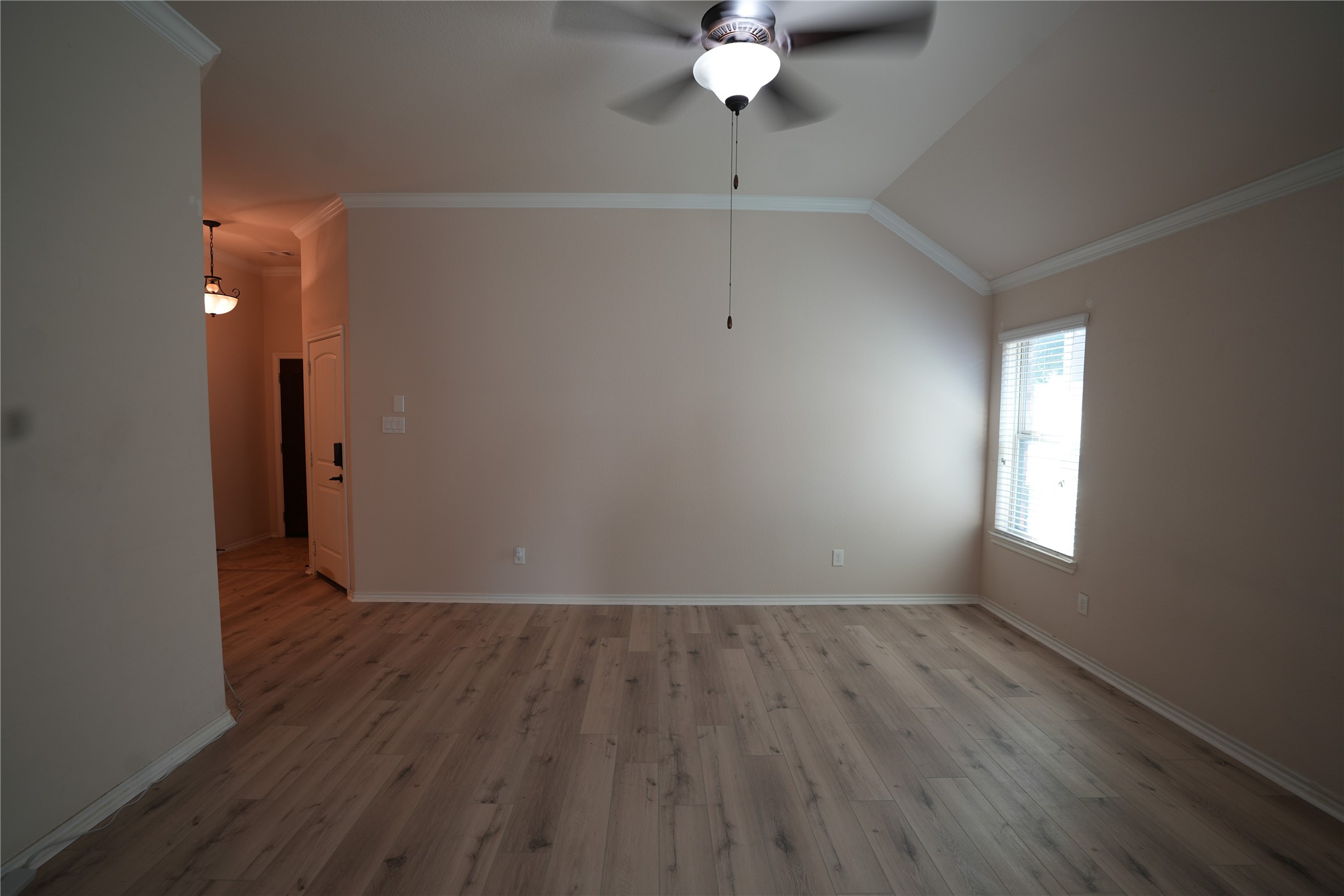 1710 Thornhampton Court Houston, TX 77014 - Photo 4 of 17 an empty room with wooden floor and mirror