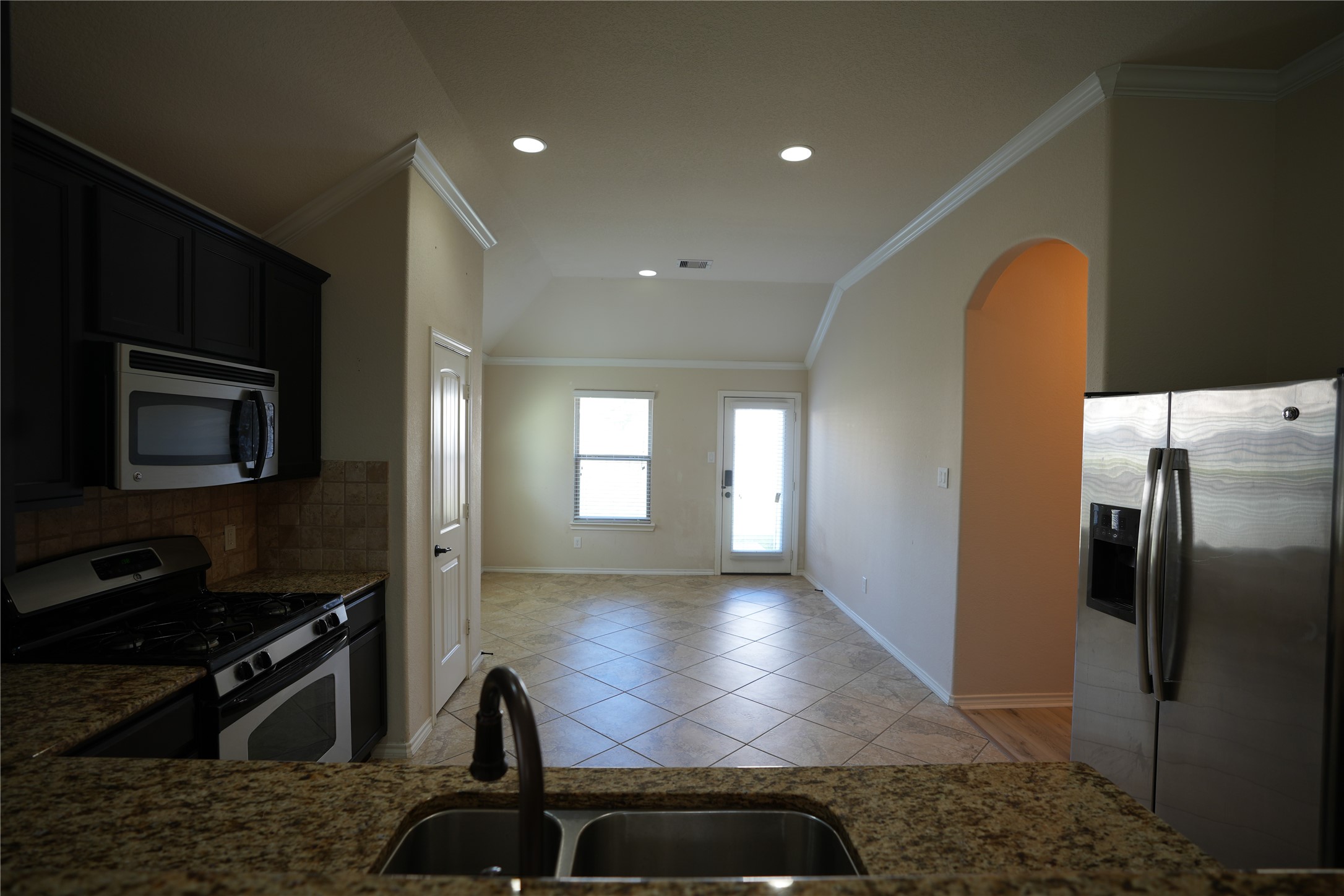 1710 Thornhampton Court Houston, TX 77014 - Photo 6 of 17 a kitchen with stainless steel appliances granite countertop a refrigerator a stove and a sink