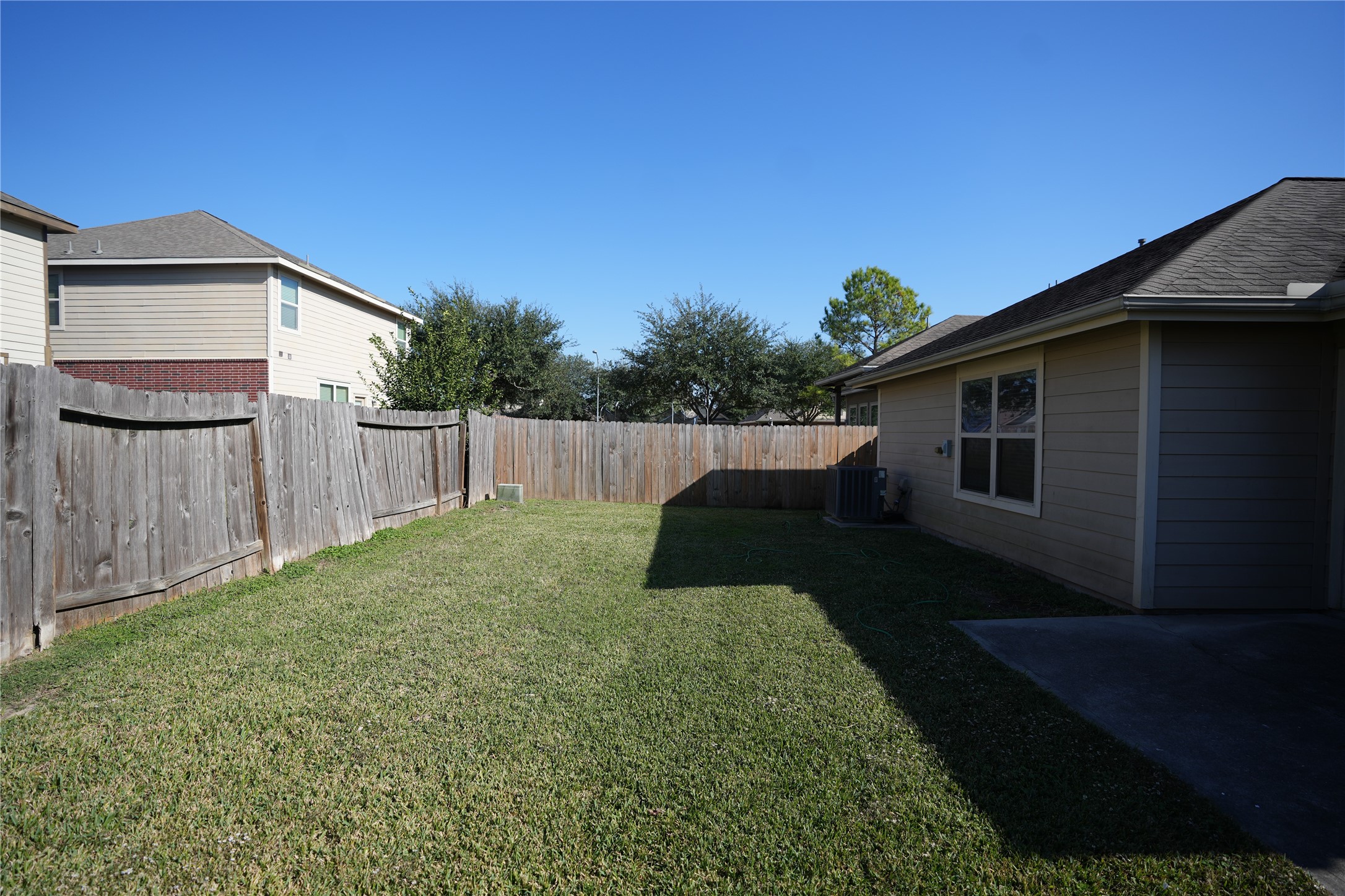 1710 Thornhampton Court Houston, TX 77014 - Photo 9 of 17 a backyard of a house with lots of green space