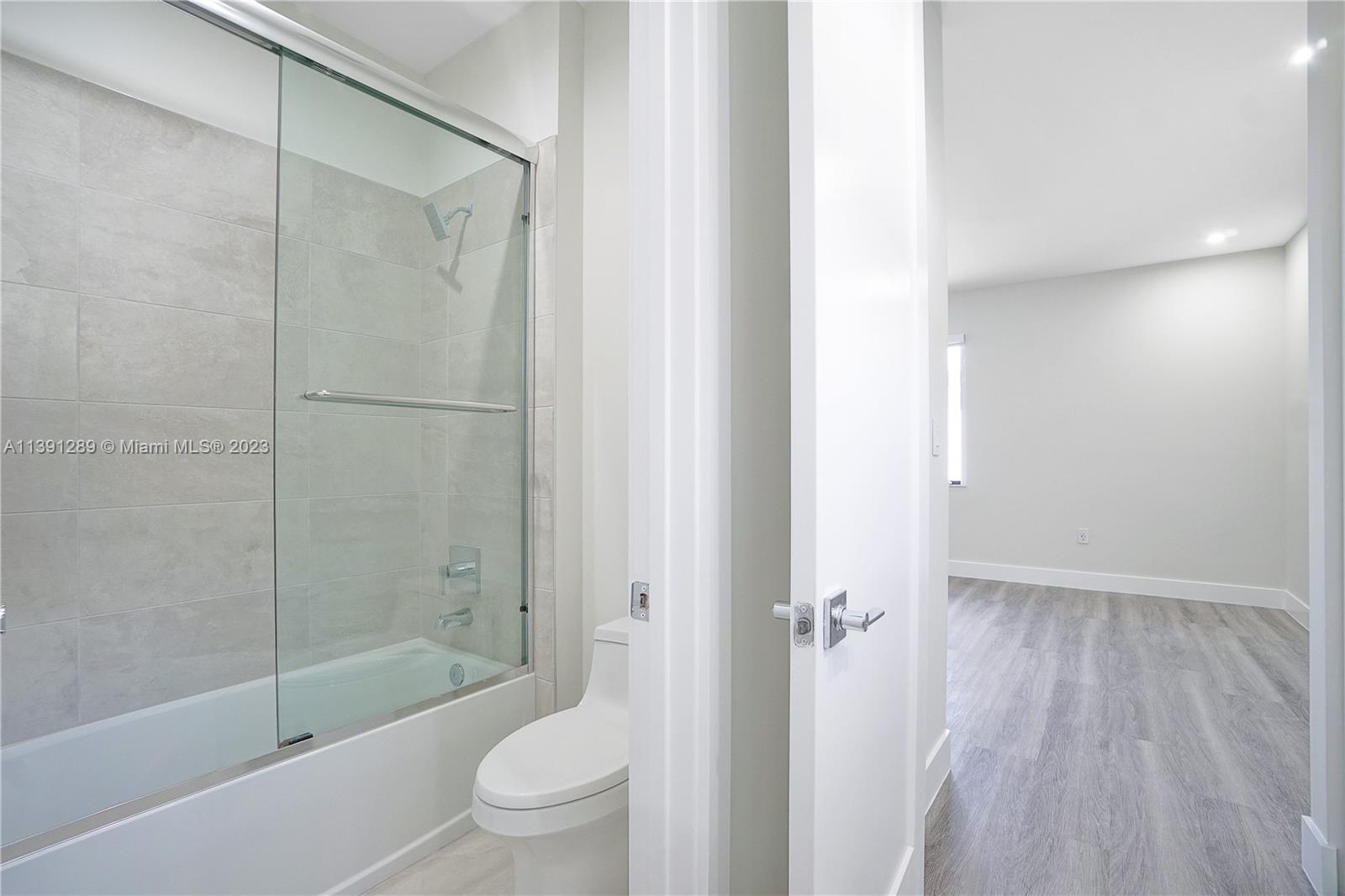 8096 Northwest 48th Terrace Doral, FL 33166 - Photo 11 of 28 a bathroom with a shower a toilet and a shower