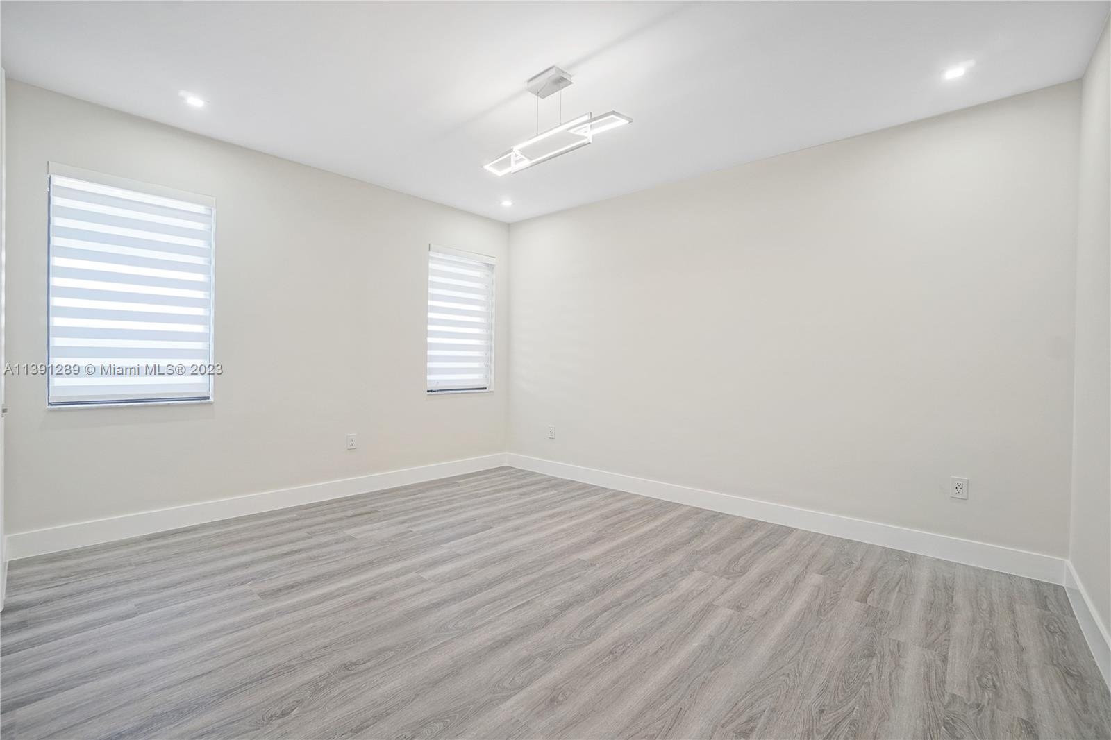 8096 Northwest 48th Terrace Doral, FL 33166 - Photo 13 of 28 an empty room with wooden floor and windows
