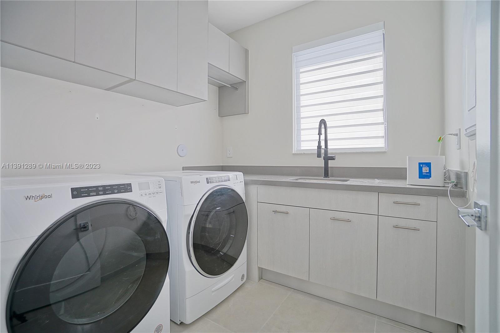 8096 Northwest 48th Terrace Doral, FL 33166 - Photo 14 of 28 a utility room with sink dryer and washer