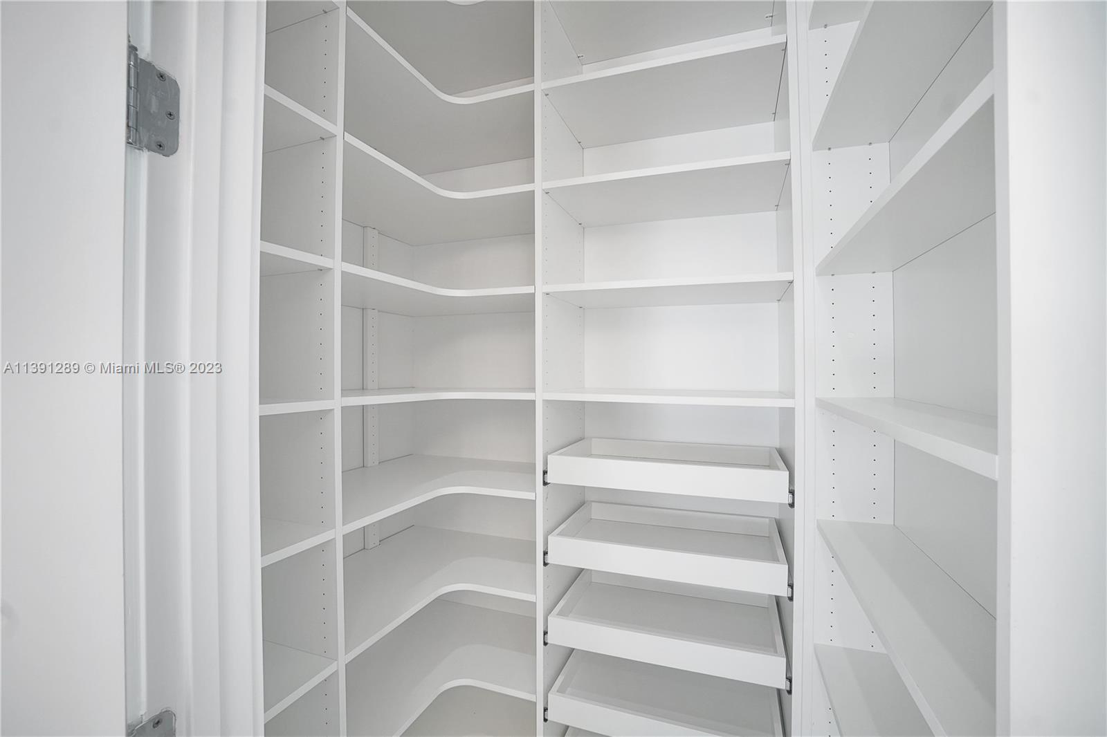 8096 Northwest 48th Terrace Doral, FL 33166 - Photo 15 of 28 a view of walk in closet with empty racks