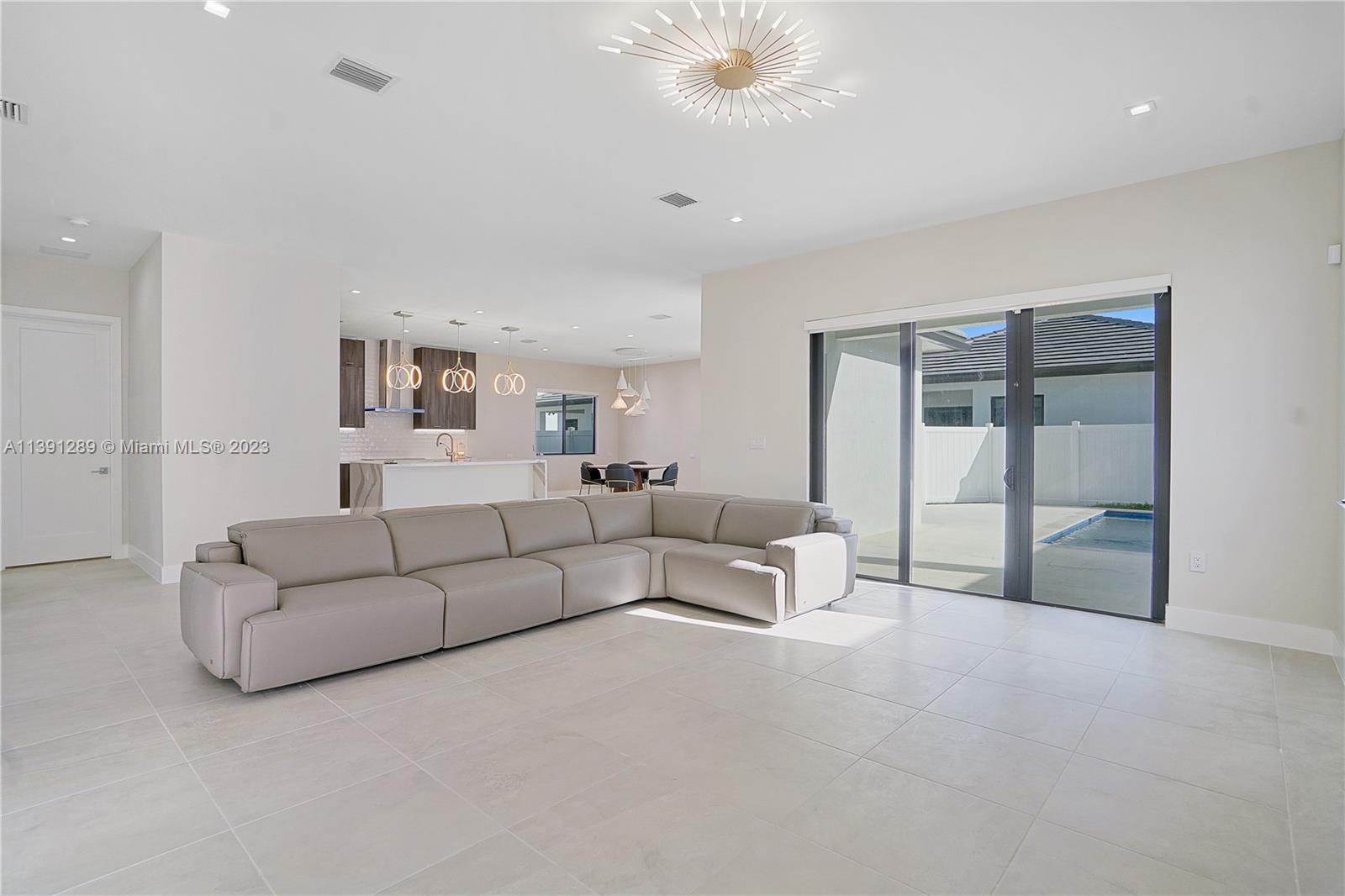 8096 Northwest 48th Terrace Doral, FL 33166 - Photo 18 of 28 a living room with furniture and a large window