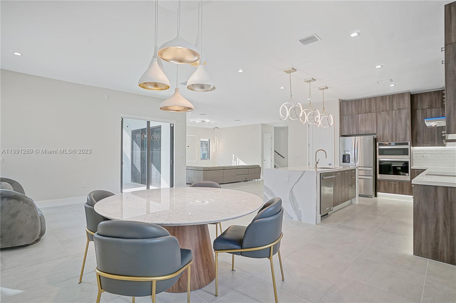8096 Northwest 48th Terrace Doral, FL 33166 - Photo 21 of 28 a kitchen with a table and chairs in it