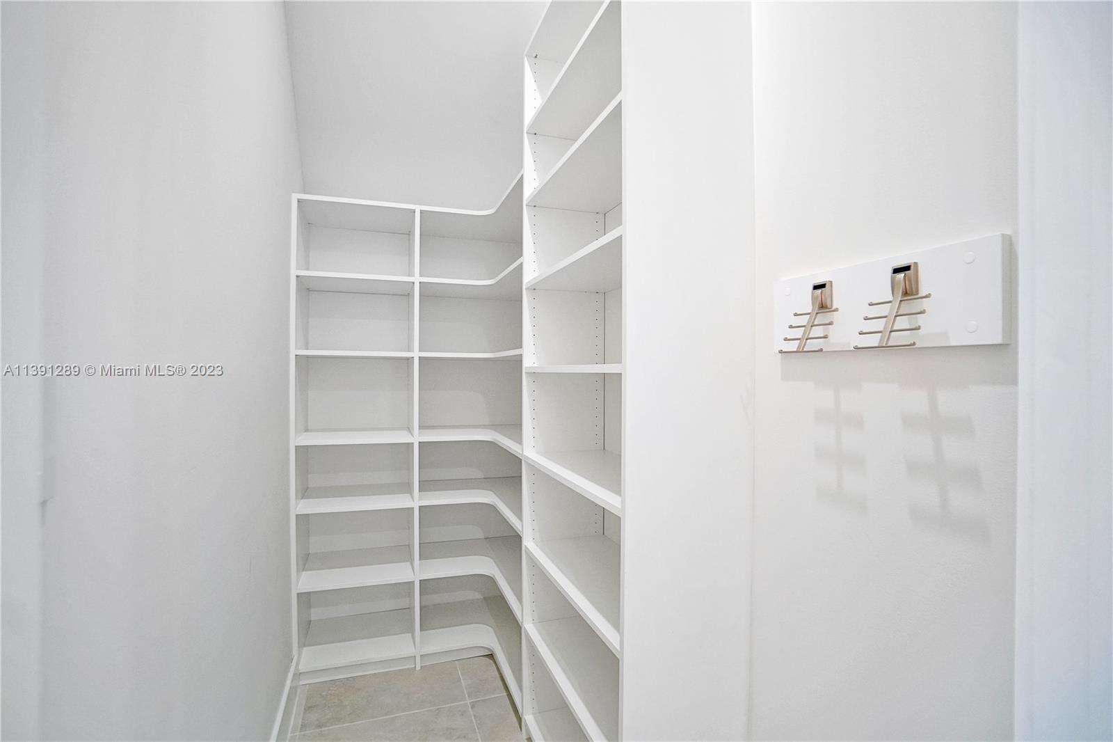 8096 Northwest 48th Terrace Doral, FL 33166 - Photo 23 of 28 a view of walk in closet with empty racks