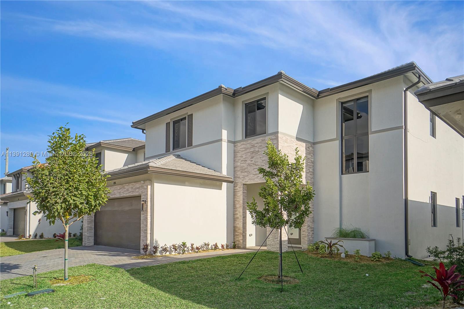 8096 Northwest 48th Terrace Doral, FL 33166 - Photo 26 of 28 a front view of a house with a yard