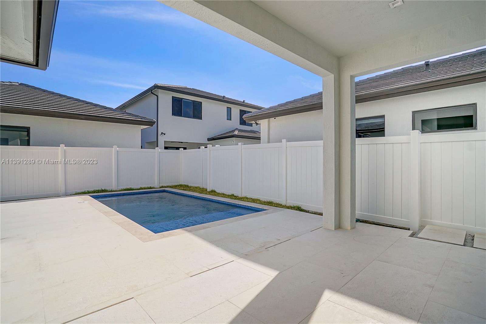 8096 Northwest 48th Terrace Doral, FL 33166 - Photo 27 of 28 a view of a backyard of the house