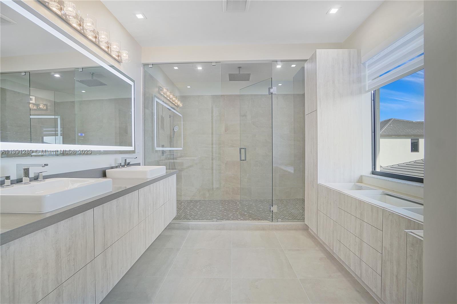 8096 Northwest 48th Terrace Doral, FL 33166 - Photo 3 of 28 a bathroom with a granite countertop sink mirror and a