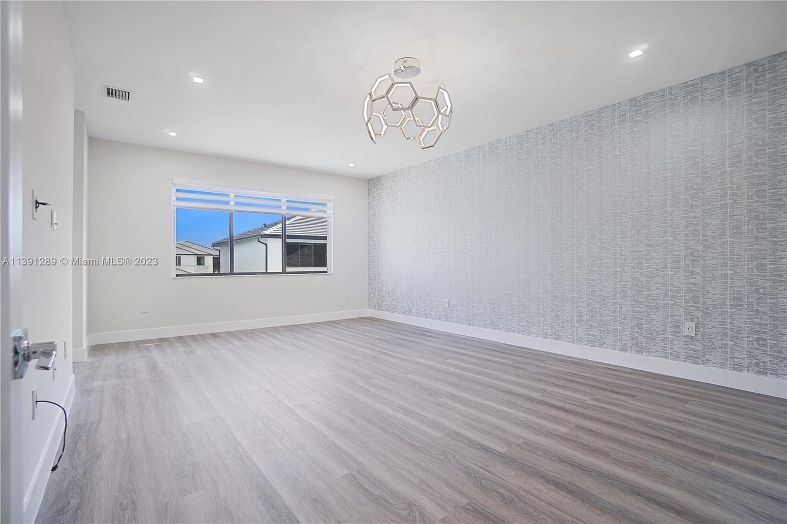 8096 Northwest 48th Terrace Doral, FL 33166 - Photo 4 of 28 a view of an empty room with wooden floor and a window