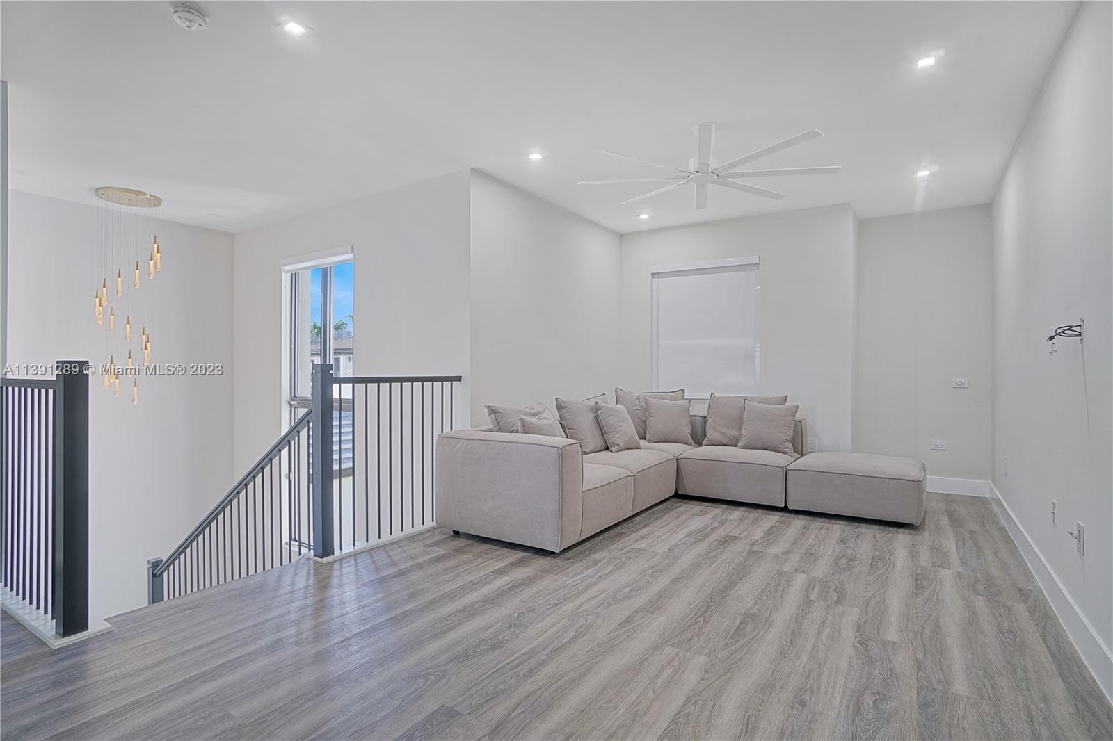 8096 Northwest 48th Terrace Doral, FL 33166 - Photo 7 of 28 a living room with furniture and a wooden floor