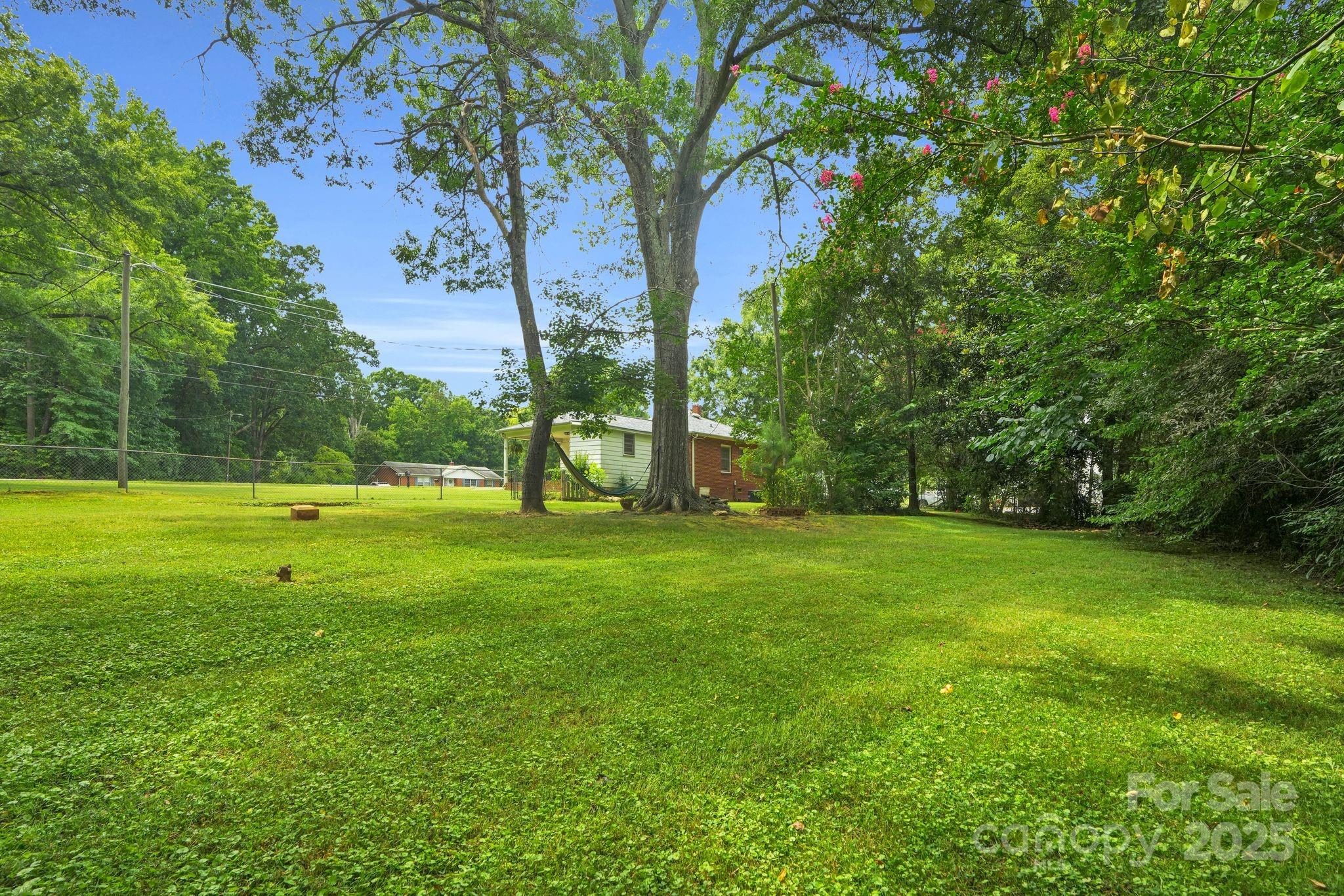 10437 Idlewild Road Matthews, NC 28105 - Photo 3 of 12 a view of a park with large trees