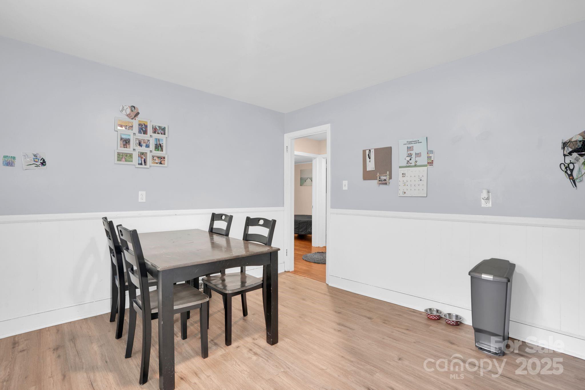 10437 Idlewild Road Matthews, NC 28105 - Photo 8 of 12 a view of a dining room with furniture and wooden floor