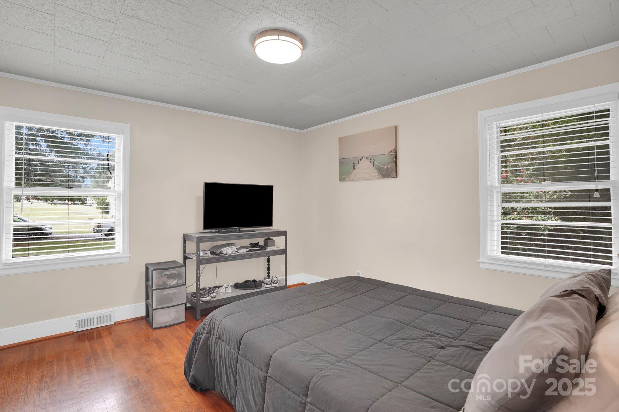 10437 Idlewild Road Matthews, NC 28105 - Photo 9 of 12 a bedroom with a bed and a television